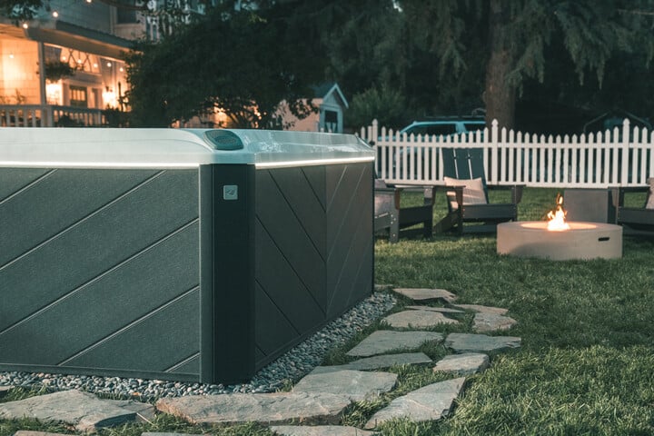 sundance spas hot tub installation with a stone hot tub foundation